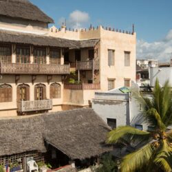 Private residence in Lamu town. Lamu Town on Lamu Island is Kenya's oldest continually inhabited town, and was one of the original Swahili settlements along coastal East Africa. It is believed to have been established in 1370.
Today, the majority of Lamu's population is Muslim.
The town was first attested in writing by an Arab traveller Abu-al-Mahasini, who met a judge from Lamu visiting Mecca in 1441.
In 1505, the Portuguese invaded Lamu, forcing the king of the town to quickly concede to paying protection money to them. The Portuguese invasion was prompted by the nation's successful mission to control trade along the coast of the Indian Ocean. For a considerable time, Portugal had a monopoly on shipping along the East African coast and imposed export taxes on pre-existing local channels of commerce. In the 1580s, prompted by Turkish raids, Lamu led a rebellion against the Portuguese. In 1652, Oman assisted Lamu to resist Portuguese control.